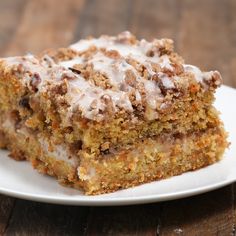 a piece of cake sitting on top of a white plate next to a wooden table