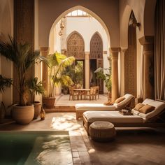 an indoor swimming pool with lounge chairs and potted plants in the middle, surrounded by arched doorways