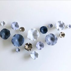 several pieces of glass sitting on top of a white surface with holes in the middle