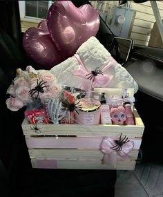 a car trunk filled with lots of pink and white items next to balloons in the back seat