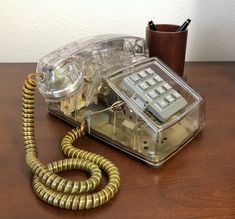 an old fashioned telephone sitting on top of a wooden table