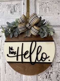 a wooden sign with the word hello on it