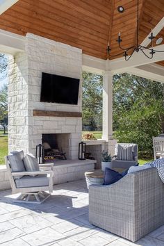 an outdoor living area with furniture and a fireplace