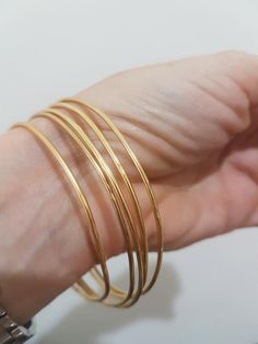 Gold bangle bracelet, made of a 1.5 mm gold plated wire, designed in a minimalist, simple chic.Available as a single gold bangle, set of 2 or 3, 4 or even 5 gold bangles these bracelets will make a beautiful addition for every look, day or night.Dimensions:The bangle bracelet diameter is available in sizes: small (2.35"), medium (2.5") or large (2.75"). If you require a different size just convo me.The bangle is 1.5mm thickFor a thicker version of gold bangles, follow the link below:https://www. Single Gold Bangle, Gold Bangle Bracelet For Women, Simple Gold Bangle, 14k Gold Bangle Bracelet, Plain Gold Bangles, Bangle Bracelet Gold, Gold Bangles For Women