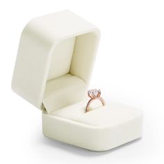 an open ring box with a diamond in it