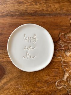 a white plate sitting on top of a wooden table