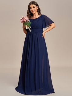 a woman in a long blue dress holding flowers