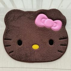 a hello kitty rug with a pink bow on it