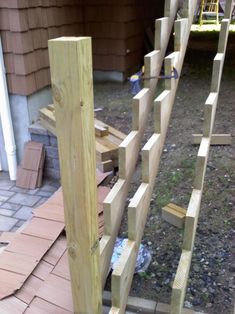 a wooden fence made out of wood planks on the side of a house,