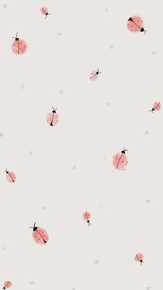 a pink wallpaper with ladybugs and stars in the background on a light gray surface