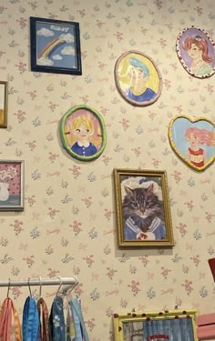 there are many pictures on the wall with cats and other things around them in this room