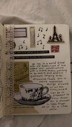 an open notebook with various stickers and writing on it, including a coffee cup