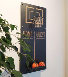 there is a sign that says home guest with basketballs on it