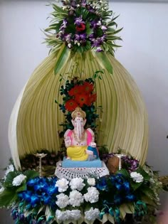 an elephant statue sitting on top of a table with flowers and candles around it that reads good morning