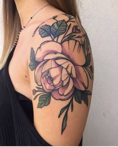 a woman's shoulder with a rose tattoo on her left arm and the other half sleeve