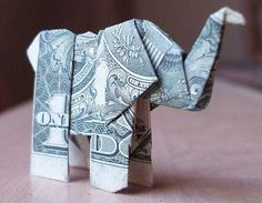 an origami elephant made out of money