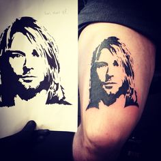 a person with a tattoo on their leg next to a drawing of a man's face