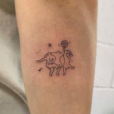 a small tattoo on the leg of a man with an elephant holding a basketball ball