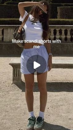 a woman standing in front of a fountain with her hand on her head and the caption make sandi shorts with me