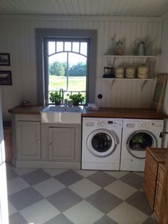 a kitchen with a sink, washer and dryer next to an open window