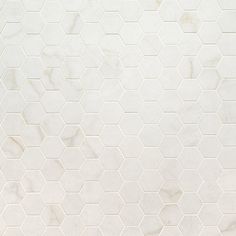 a white marble wall with hexagonal tiles