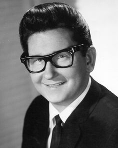 a black and white photo of a man wearing glasses