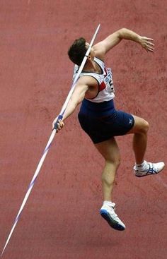 a man is jumping in the air with a pole