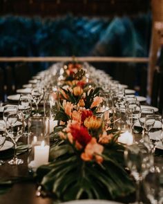 a long table is set with candles and flowers for a formal dinner or wedding reception