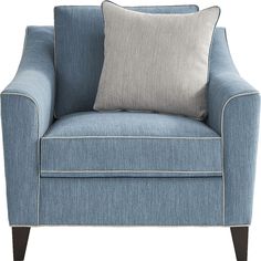 a blue chair with two pillows on top of the armrests and an accent pillow