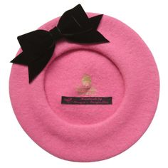 Pure wool pink French beret hat with a black velvet ribbon bow. This pure wool beret is machine made and customised with a hand sewn black velvet ribbon bow.  - Ladies One Size: Fits an average head size of approximately 21-22 inches.  - Approximately 25cm (10 inches) in diameter Thanks to the 100% wool content, this beret does stretch with regular wearing. NB: Unfolding the inner lip of the hat will instantly make this French style beret fit a larger head size Also available with a pink velvet Velvet Ribbon Bow, Pink Velvet Ribbon, Pink Beret, Felt Beret, French Beret Hat, French Hat, Black Velvet Ribbon, French Beret, Pink French