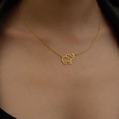 "Choose this beautiful elephant necklace for a cute reminder of mindful moments. Created by hand this gorgeous gold elephant necklace makes a perfect gift for the person who brings you joy. Wear this wealthy symbol necklace close to your heart to share with others how much you deeply care about their well being.  * Material: 14K Solid Gold (real solid gold, no gold-filled or no gold plated material), 925 Sterling Silver  * Choice of Gold Color: Yellow Gold, Rose Gold, White Gold  * Closure: Spring ring  * Chain style: Cable  * Style: Minimalist Thinking of gifting? Elevate your order with our Christmas Gift Wrap option! 🎁 Buy from here! https://www.etsy.com/listing/1580219719/ M O R E F R O M U S Mionza Jewels' pieces are handcrafted by 30 years of experienced craftsmen and made to order. Elephant Jewelry Necklace, Location Names, African Necklaces, Gold Elephant Pendant, Elephant Necklace Gold, Beautiful Elephant, Mindful Moments, Minimal Gold, Elephant Jewelry