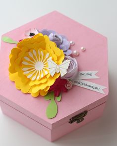 a pink box with paper flowers on it