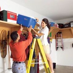 a man and woman standing on top of a yellow ladder in a room filled with shoes