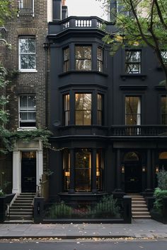 a black building with many windows and stairs