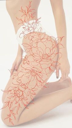 a woman is kneeling down with her legs crossed and flowers drawn on the side of her body