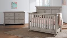 a baby's room with a crib, dresser and bed