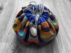 a multicolored bag sitting on top of a wooden floor