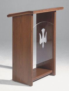 a wooden podium with a glass plaque on it's front and side panels in the center