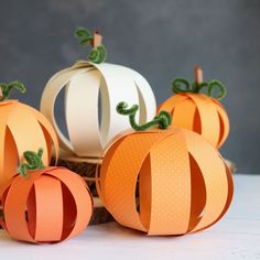 four paper pumpkins sitting on top of each other