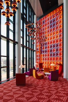 the lobby is decorated with colorful lights and modern furniture, as well as floor to ceiling windows