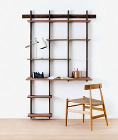 a wooden chair sitting in front of a book shelf