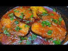 some food is being cooked in a pan on the stove with garnishes