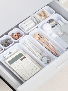 an organized drawer is shown with various items and utensils in it's drawers