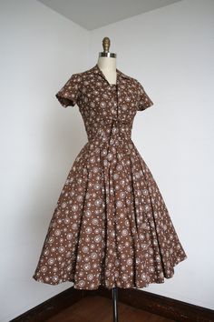 "Wonderful brown cotton sun dress and jacket set from the 1950s. This set features a wonderful German style print that includes Hearts! Reminds me of a Lanz piece to be honest. Metal zipper.  Label: Jerry Gilden  Measurements: { xsmall } Bust: 34\"  Waist: 24\" snug Hips: open Length: 42\" Condition: nearly excellent vintage condition with maybe a hint of uneven fading when you *really* look at it but presents beautifully. minor signs of wear - sold as found. washed and ready to wear ☆Shop more☆ http://www.trunkofdresses.com/" Cheap Vintage Knee-length Midi Dress, Cheap Retro Dresses With Buttons, 1950s Dresses, Vintage Style Clothing Women, Elegant Vintage Dresses Miggon 🛍️, 1950s A-line Dress With Buttons, 1950s Spring Vintage Dress With Buttons, Vintage Dresses Miggon 🛍️, 1950s Collared Daywear Dresses