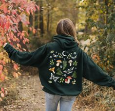 If you're looking for a Nature inspired aesthetic hoodie, this Mushrooms Fern and Mystical Moths Botanical Pullover is an wonderful choice! This unisex heavy blend hooded sweatshirt is relaxation itself. Made with a thick blend of cotton and polyester, it feels plush, soft and warm, a perfect choice for any cold day. This Mystical Moths Hooded Sweatshirt features beautiful and attractive botanical collage of hand drawn mushrooms, moths, woodland plants and fern. Our Forest core Pullover is a pretty gift for yourself and for all Plant Ladies and Nature Lovers out there. This wonderful print makes fall in love with this sweater more and more. Stay beautiful! Dress like it's your day!   Make sure to attach 10% discount on your first order with Welcome10 code at checkout! Check on more beautif Botanical Aesthetic, Woodland Plants, Forest Core, Fall Nature, Aesthetic Forest, Unique Trees, Cottagecore Aesthetic, Aesthetic Clothing