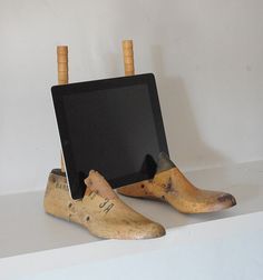 an old wooden tablet sitting on top of a pair of shoes that are made out of banana peels