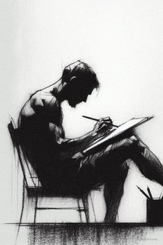 a person sitting in a chair writing on a paper