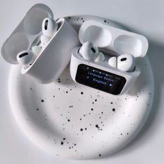 two airpods sitting on top of a white plate