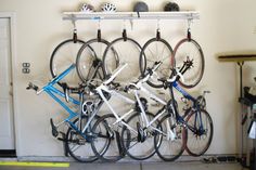 there are many bikes that are on the rack in this garage, and one is blue