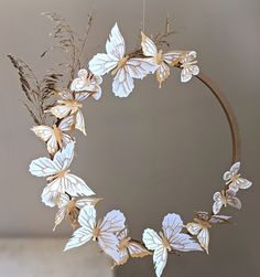 a wreath with white flowers and gold leaves